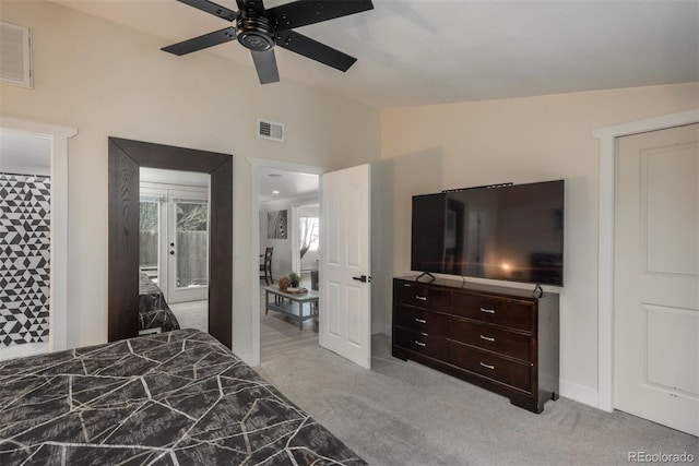 bedroom featuring lofted ceiling, light colored carpet, and ceiling fan