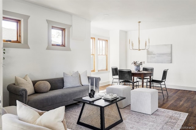 living room featuring hardwood / wood-style floors, a healthy amount of sunlight, and a notable chandelier