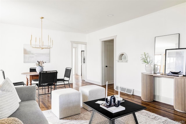 living room with an inviting chandelier and dark wood-type flooring