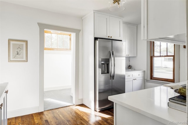 kitchen featuring white cabinets, stainless steel fridge, and dark hardwood / wood-style flooring