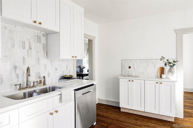 kitchen with white cabinets, dark wood-type flooring, decorative backsplash, sink, and stainless steel dishwasher