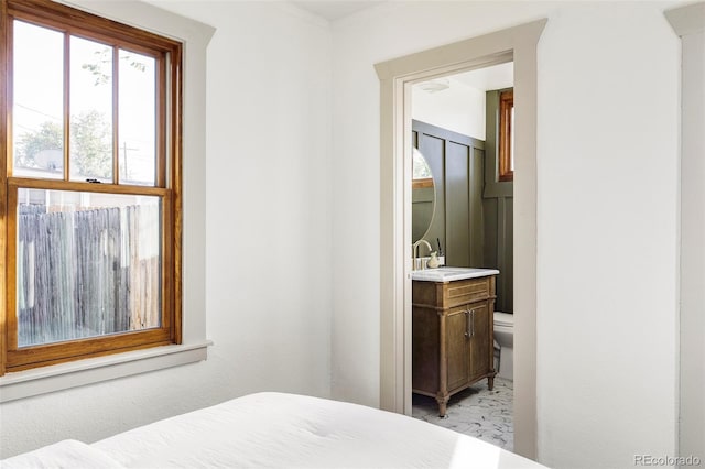 bedroom with sink and multiple windows