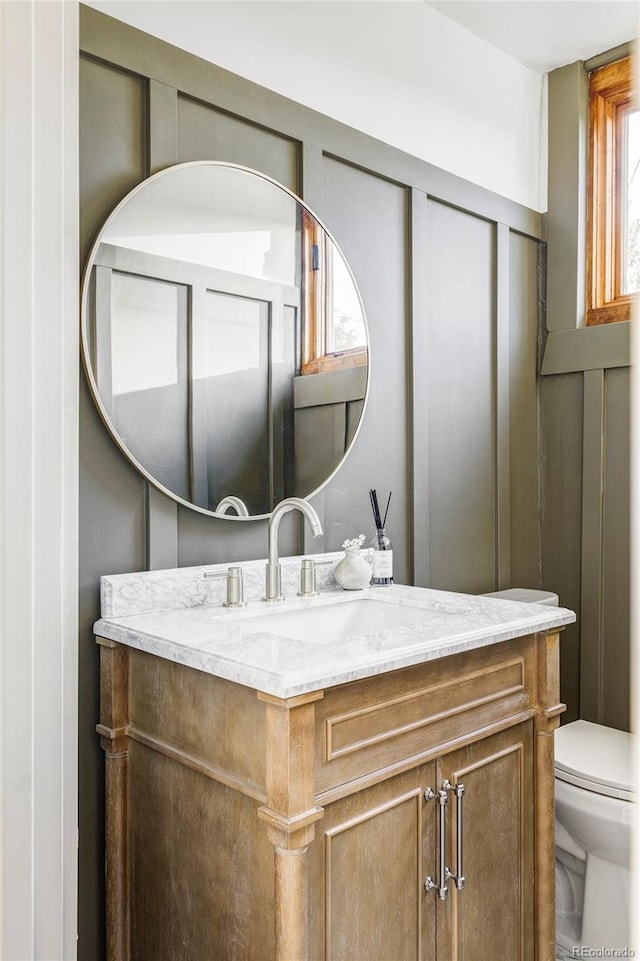 bathroom featuring toilet and vanity