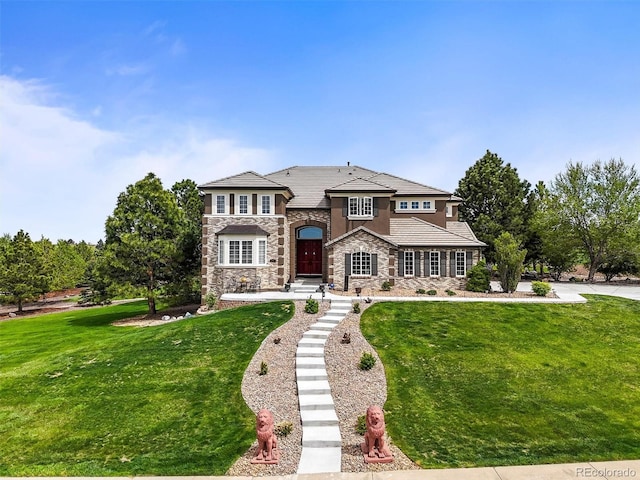 8518 High Rdg, Castle Pines, CO 80108 - view of front facade featuring stone siding and a front yard