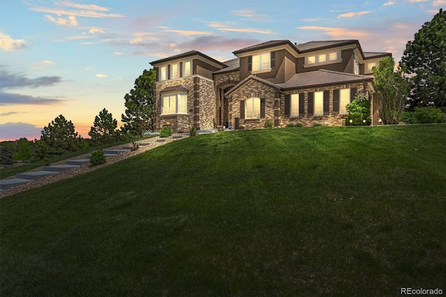 8518 High Rdg, Castle Pines, CO 80108 - view of front of property featuring stone siding, stucco siding, a yard, and a tiled roof