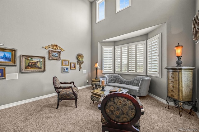 8518 High Rdg, Castle Pines, CO 80108 - carpeted living room featuring baseboards and a towering ceiling