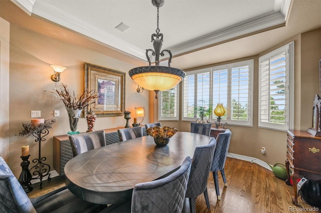 8518 High Rdg, Castle Pines, CO 80108 - dining room with ornamental molding, wood finished floors, a tray ceiling, and baseboards