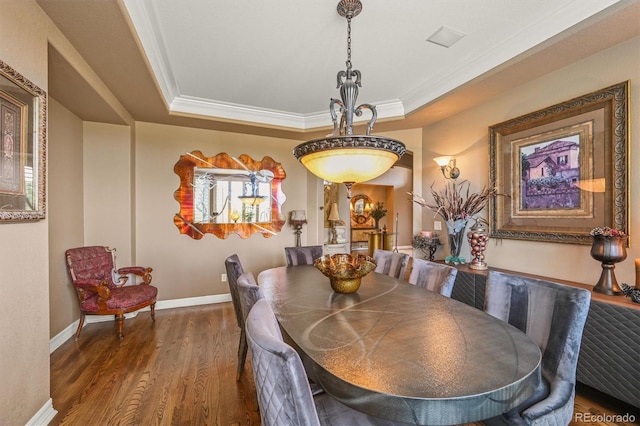 8518 High Rdg, Castle Pines, CO 80108 - dining area featuring ornamental molding, a tray ceiling, wood finished floors, and baseboards
