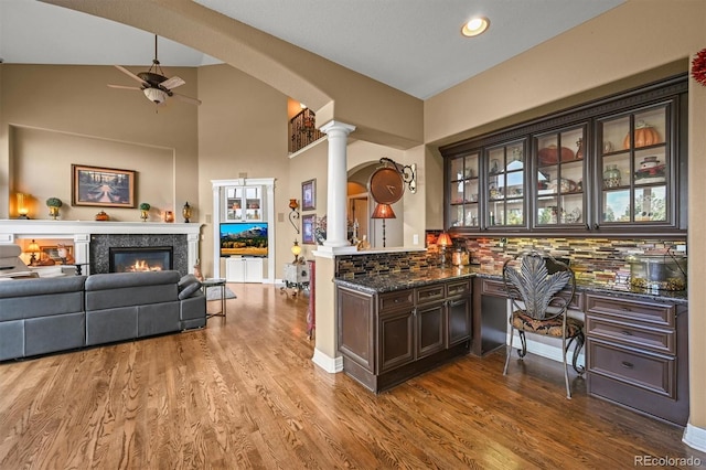 8518 High Rdg, Castle Pines, CO 80108 - bar featuring decorative columns, ceiling fan, decorative backsplash, wood finished floors, and recessed lighting