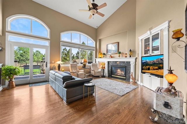 8518 High Rdg, Castle Pines, CO 80108 - living room featuring a fireplace, wood finished floors, high vaulted ceiling, and a ceiling fan
