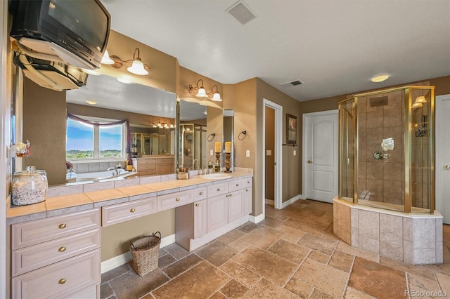 8518 High Rdg, Castle Pines, CO 80108 - full bathroom with a shower stall, baseboards, stone tile floors, double vanity, and a tub to relax in