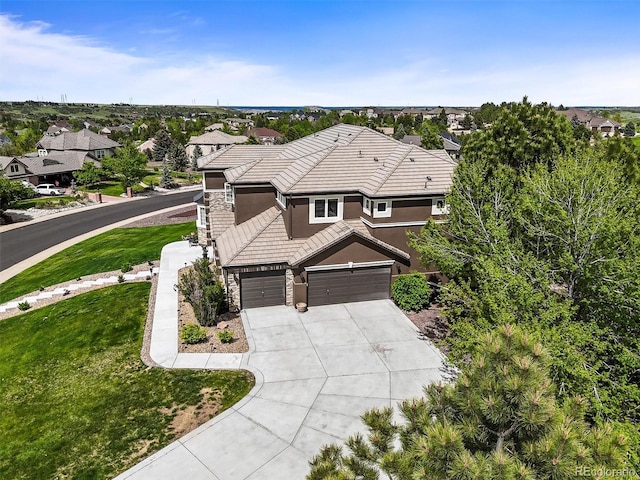 8518 High Rdg, Castle Pines, CO 80108 - view of front of property featuring stucco siding, driveway, a tiled roof, stone siding, and a front yard