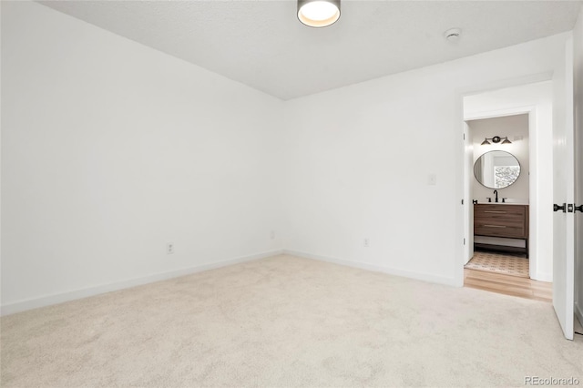 carpeted empty room with sink