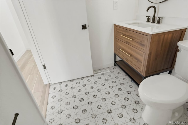 bathroom with vanity and toilet