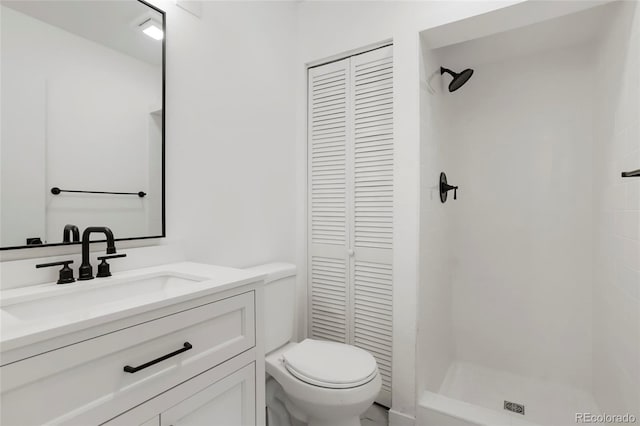 bathroom featuring vanity, toilet, and walk in shower