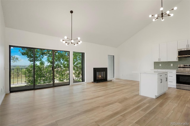 kitchen with white cabinetry, decorative light fixtures, stainless steel appliances, and a chandelier