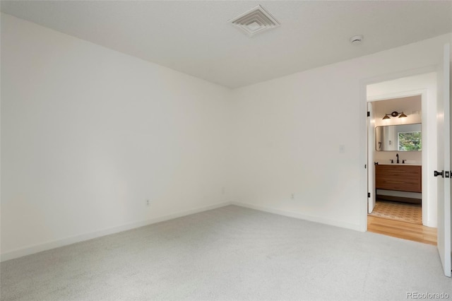 carpeted empty room featuring sink