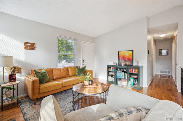 5007 S Richfield Cir, Aurora, CO 80015 - living room featuring vaulted ceiling, wood finished floors, and baseboards