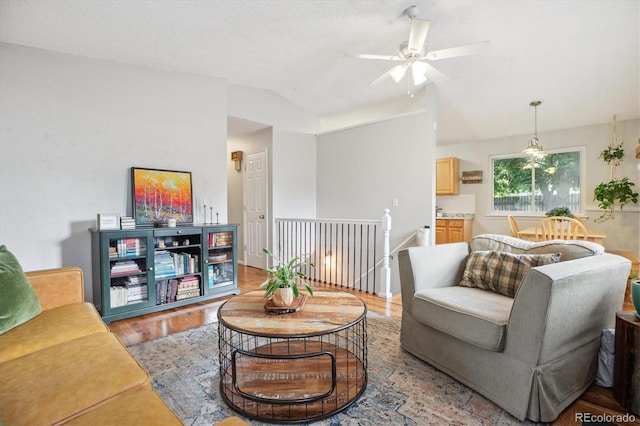 5007 S Richfield Cir, Aurora, CO 80015 - living room featuring vaulted ceiling, light wood finished floors, and a ceiling fan