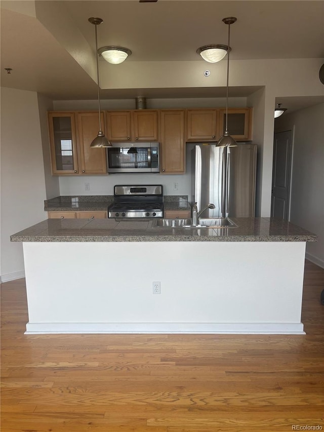 1441 Central St Unit 211, Denver, CO 80211 - kitchen featuring stainless steel appliances, a sink, dark countertops, and hanging light fixtures