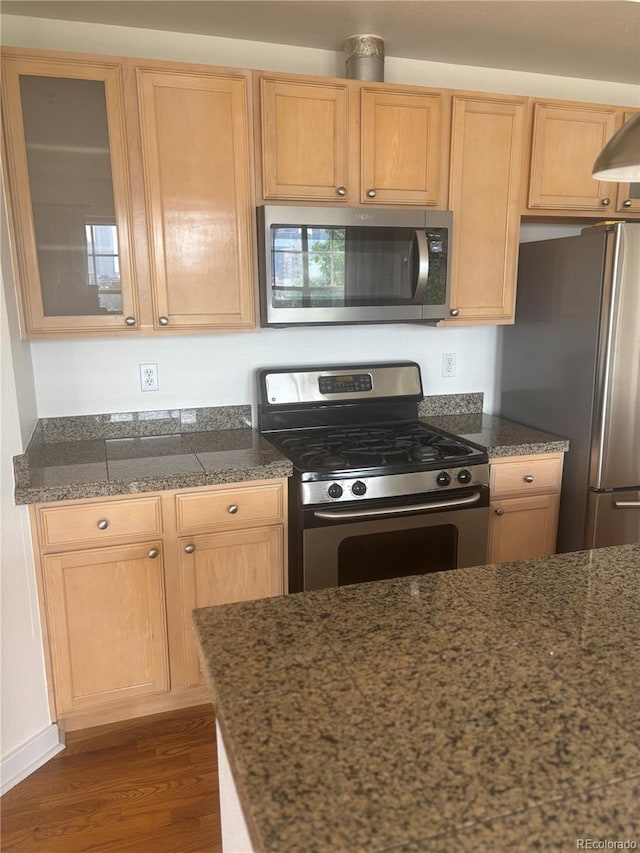 1441 Central St Unit 211, Denver, CO 80211 - kitchen featuring stainless steel appliances, wood finished floors, glass insert cabinets, and light brown cabinets