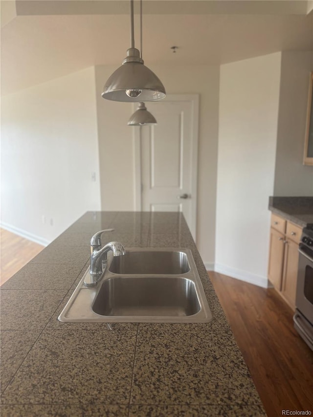 1441 Central St Unit 211, Denver, CO 80211 - kitchen with a sink, tile countertops, stove, dark wood-style floors, and pendant lighting