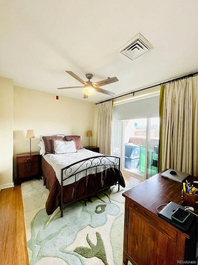 1441 Central St Unit 211, Denver, CO 80211 - bedroom featuring access to outside, ceiling fan, and wood finished floors
