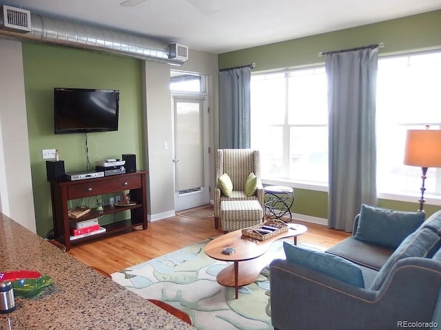 1441 Central St Unit 211, Denver, CO 80211 - living room featuring healthy amount of natural light, light wood-style flooring, and baseboards