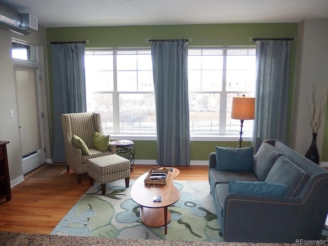 1441 Central St Unit 211, Denver, CO 80211 - living area with wood finished floors, plenty of natural light, and baseboards