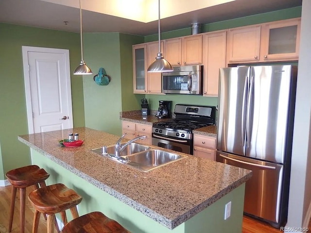 1441 Central St Unit 211, Denver, CO 80211 - kitchen with stainless steel appliances, a sink, a breakfast bar area, and glass insert cabinets