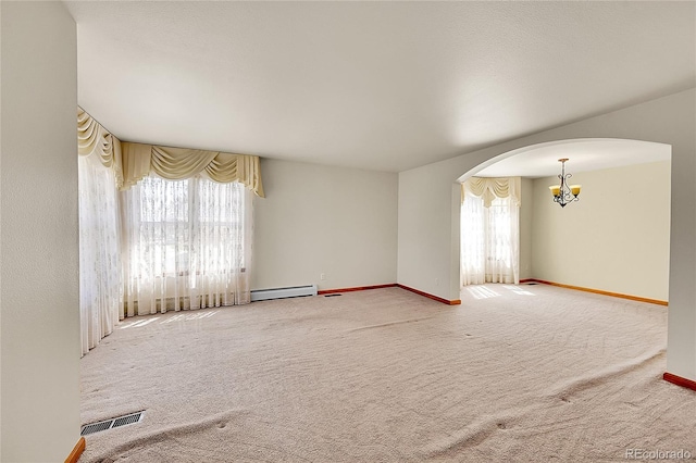 carpeted spare room featuring visible vents, arched walkways, an inviting chandelier, and a healthy amount of sunlight