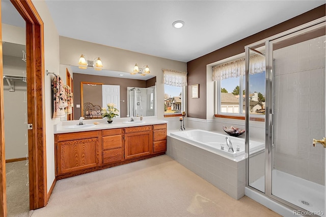 bathroom with a garden tub, a sink, and a stall shower