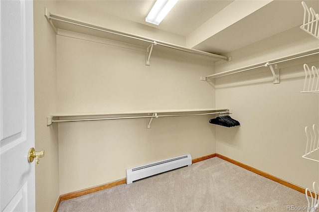 walk in closet featuring baseboard heating and carpet floors