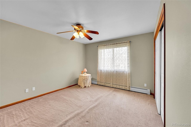 carpeted empty room with baseboard heating, baseboards, and a ceiling fan
