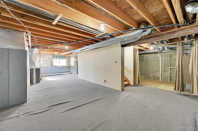 basement featuring carpet, a baseboard heating unit, and stairs