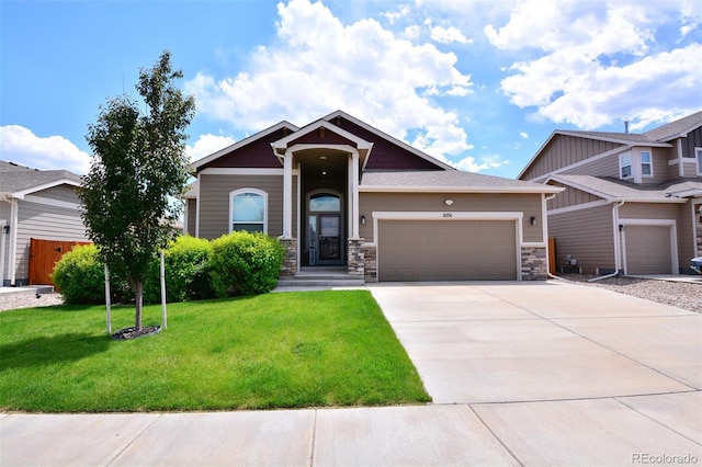 10511 Desert Bloom Way, Colorado Springs, CO 80925 - craftsman-style home with driveway, an attached garage, a front lawn, and stone siding