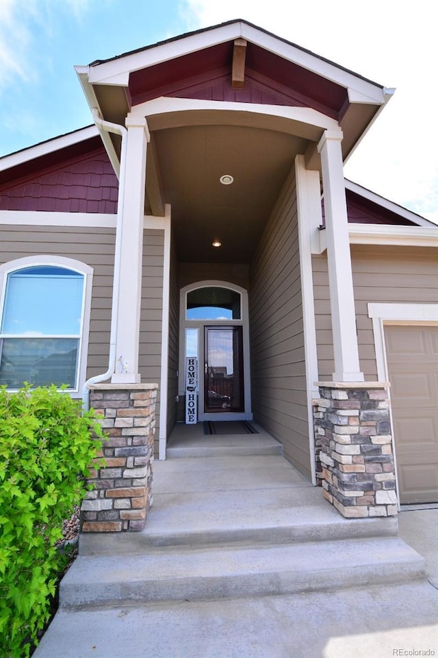 10511 Desert Bloom Way, Colorado Springs, CO 80925 - doorway to property with stone siding and an attached garage