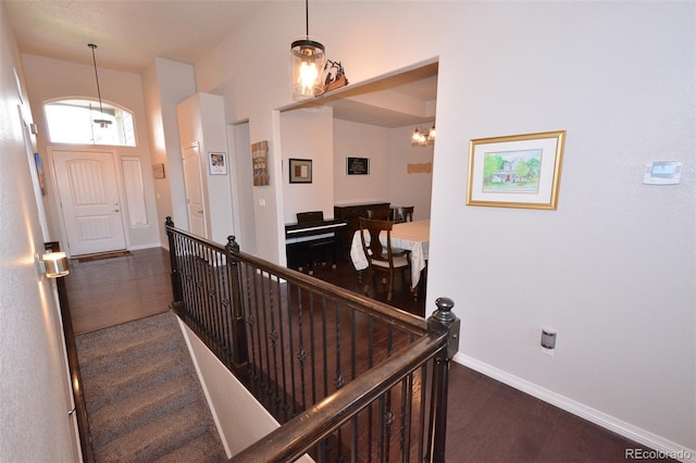 10511 Desert Bloom Way, Colorado Springs, CO 80925 - stairway with wood finished floors and a chandelier