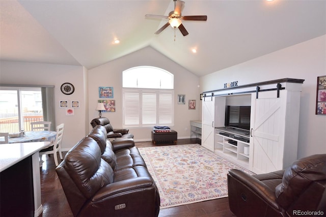 10511 Desert Bloom Way, Colorado Springs, CO 80925 - living area featuring vaulted ceiling, healthy amount of natural light, dark wood-type flooring, a ceiling fan, and a barn door