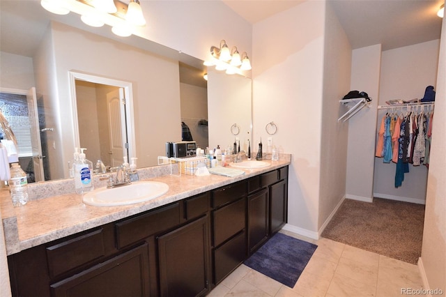 10511 Desert Bloom Way, Colorado Springs, CO 80925 - bathroom with double vanity and a walk in closet
