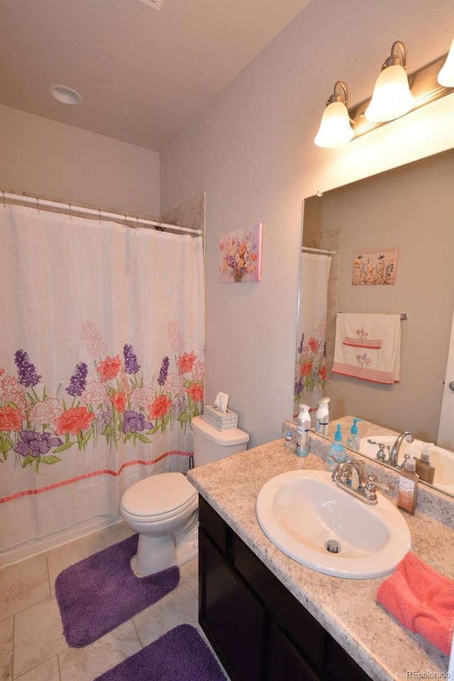10511 Desert Bloom Way, Colorado Springs, CO 80925 - full bath featuring vanity, curtained shower, and tile patterned floors