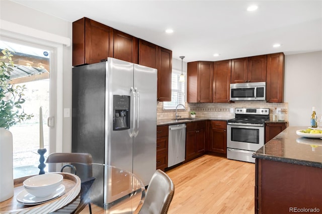2756 E Euclid Ave, Centennial, CO 80121 - kitchen featuring appliances with stainless steel finishes, a sink, tasteful backsplash, dark stone counters, and recessed lighting
