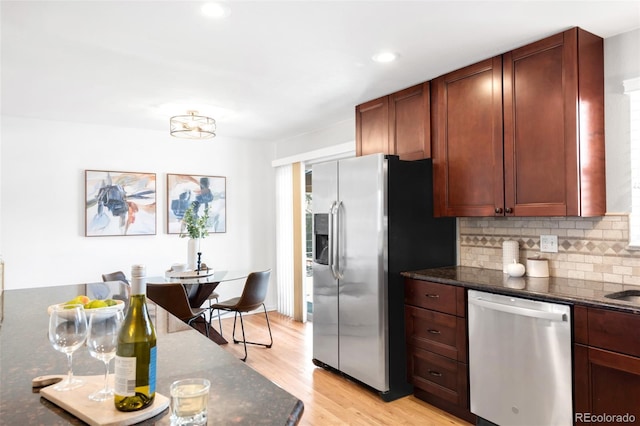 2756 E Euclid Ave, Centennial, CO 80121 - kitchen featuring appliances with stainless steel finishes, decorative backsplash, light wood-style flooring, dark stone countertops, and recessed lighting