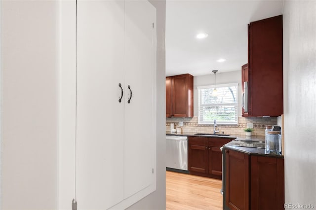 2756 E Euclid Ave, Centennial, CO 80121 - kitchen featuring dishwasher, a sink, dark countertops, backsplash, and light wood-type flooring