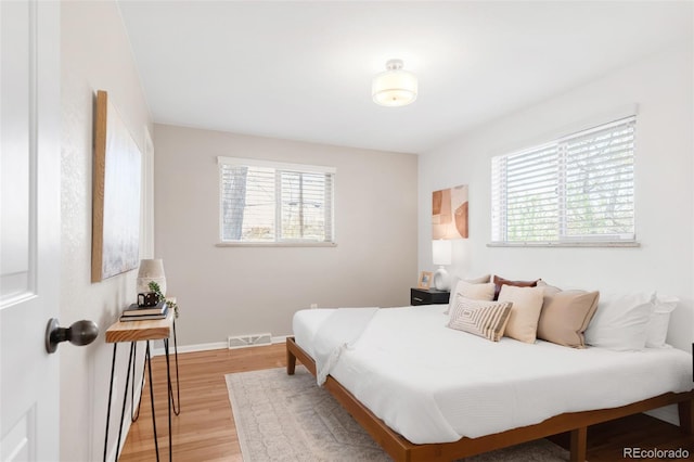 2756 E Euclid Ave, Centennial, CO 80121 - bedroom featuring multiple windows, light wood-style flooring, and baseboards