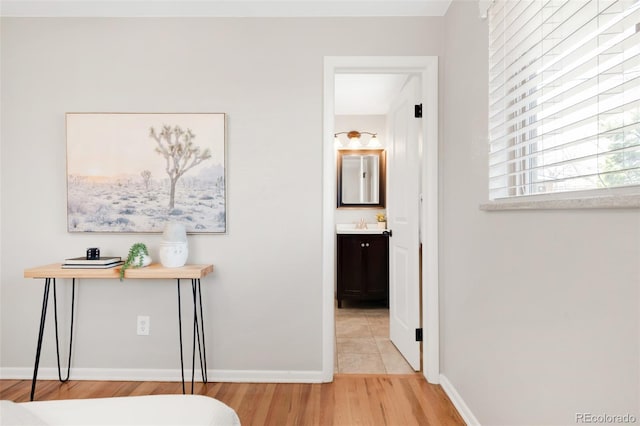 2756 E Euclid Ave, Centennial, CO 80121 - hallway featuring light wood-style floors, baseboards, and a sink