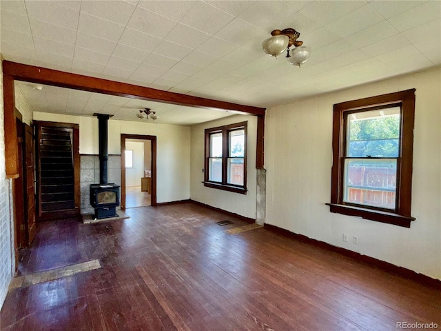 227 Milton St, Briggsdale, CO 80611 - unfurnished living room with a wood stove and hardwood / wood-style flooring