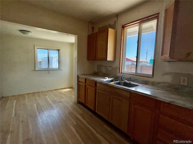 227 Milton St, Briggsdale, CO 80611 - kitchen with light wood finished floors, plenty of natural light, brown cabinets, and light countertops