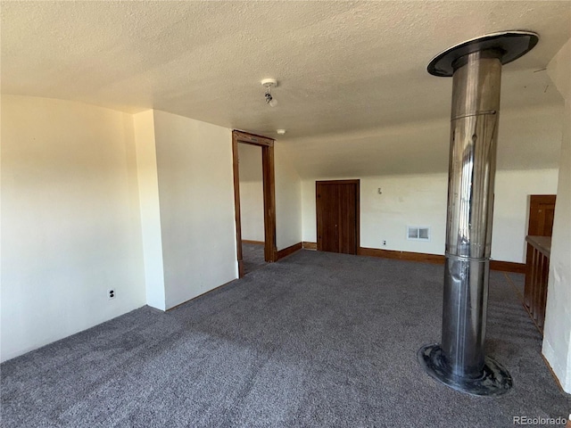 227 Milton St, Briggsdale, CO 80611 - empty room with dark carpet and a textured ceiling