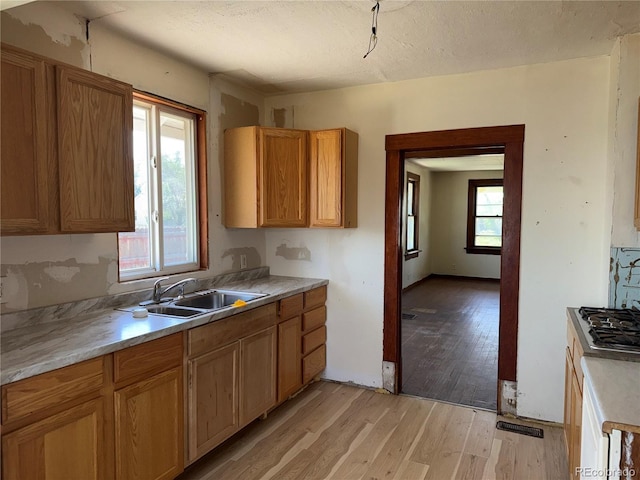 227 Milton St, Briggsdale, CO 80611 - kitchen with light wood-type flooring, light countertops, and stainless steel gas cooktop
